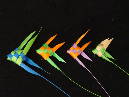 Four colorful Chinese bamboo woven tropical fish in blue, green, orange and pink on black background