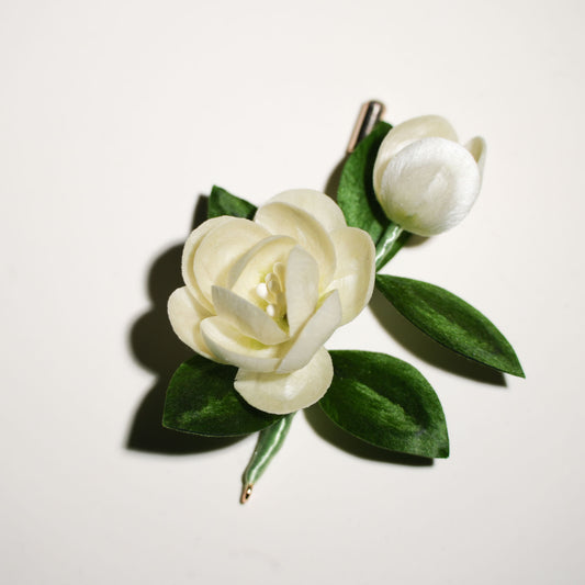 Velvet flower jasmine brooch close-up showing delicate white petals and leaf details