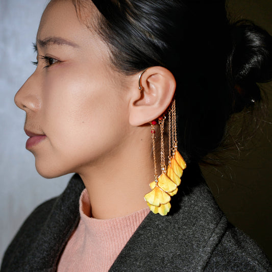 Woman wearing yellow ginkgo leaf velvet flower ear hooks - full styling example