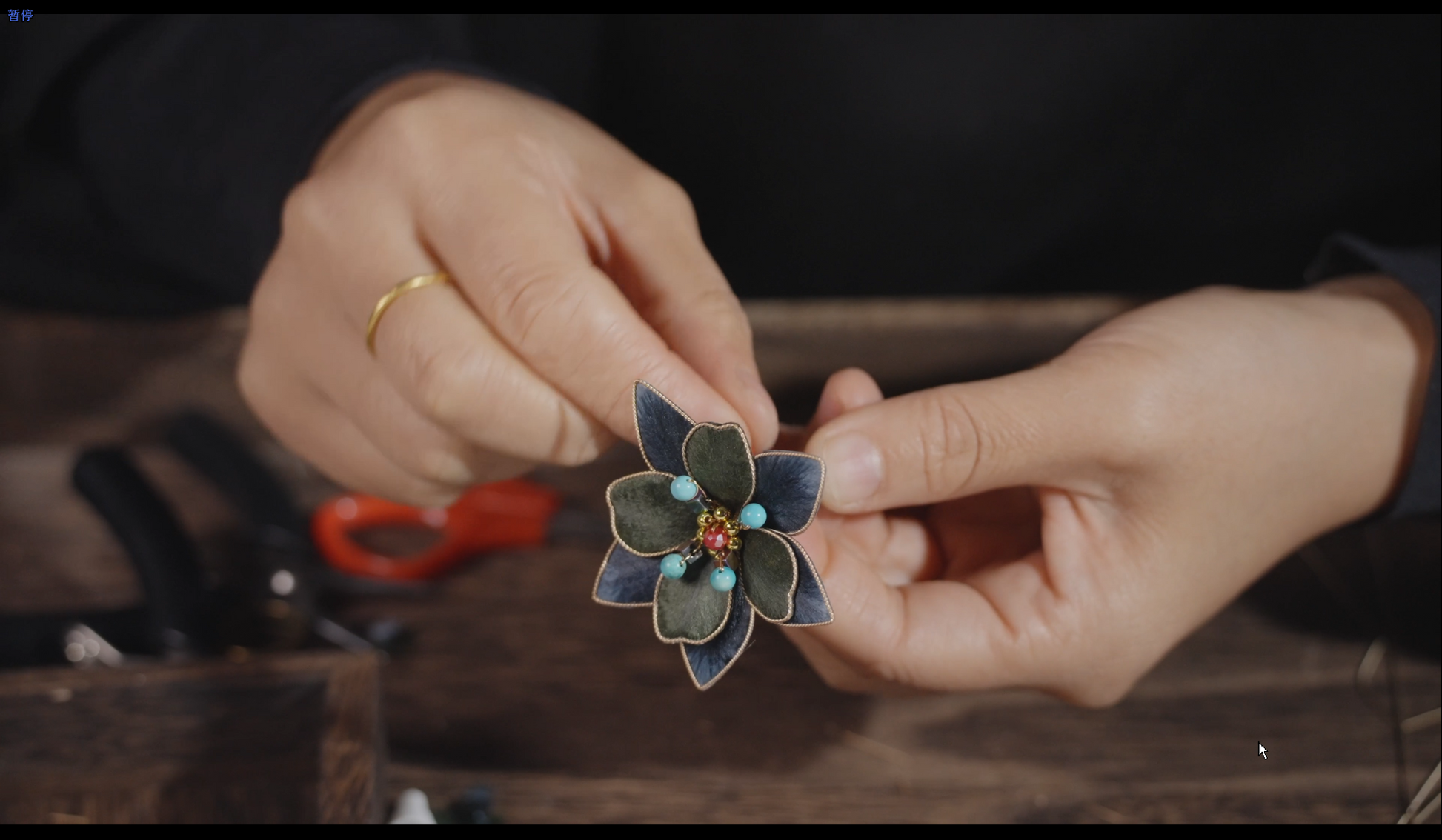 Hands crafting velvet flower tasseled hair stick showing traditional Chinese silk floss technique