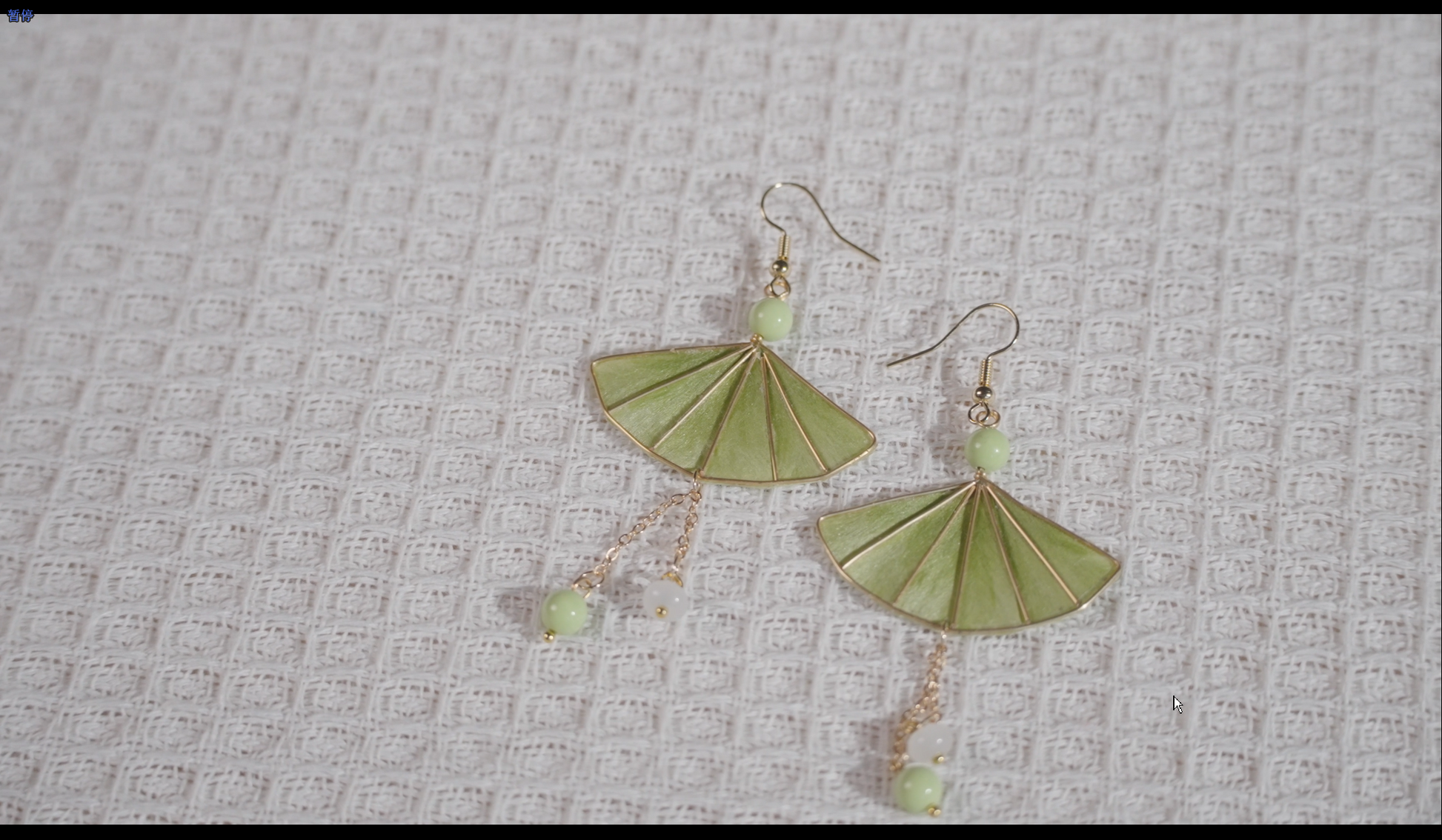 Velvet flower fan earrings on textured background showing elegant design and craftsmanship