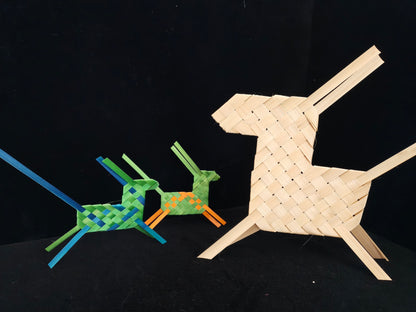 Two small colorful bamboo horses and one large natural bamboo horse on black background
