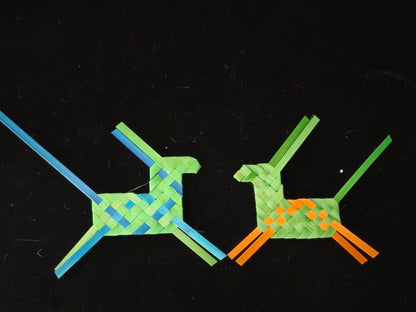 Two handmade bamboo weaving horses with colorful patterns displayed on black background
