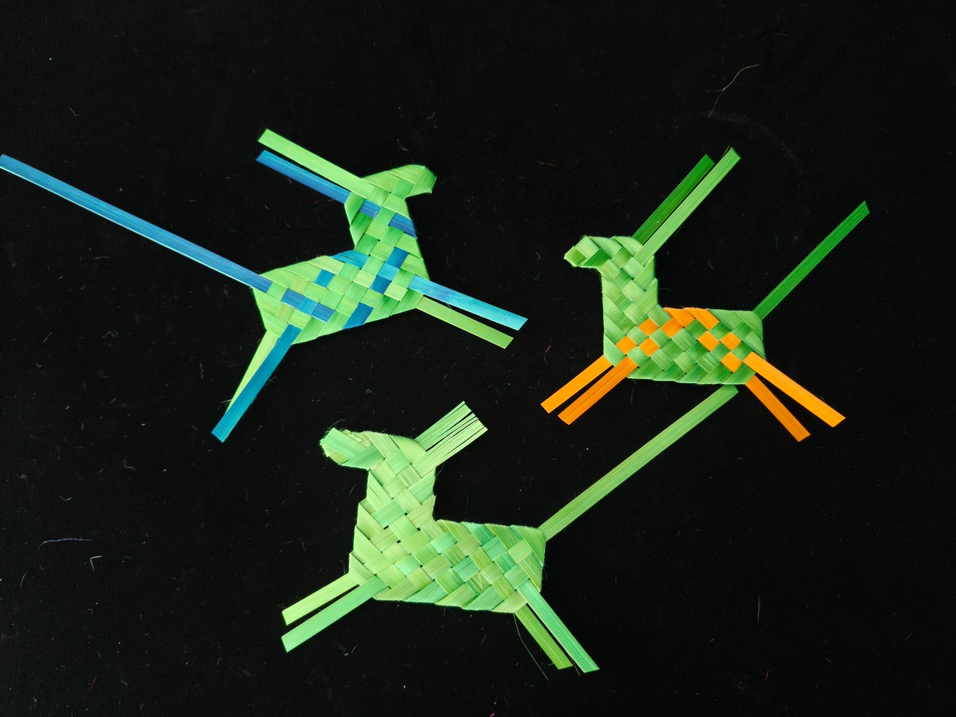 Three colorful bamboo woven horses in vibrant colors on black background - Chinese craft
