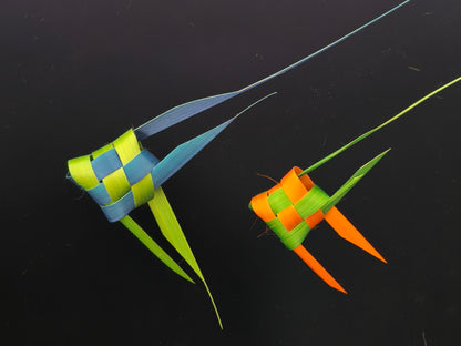 Two handmade bamboo weaving tropical fish with vibrant colors displayed on black background
