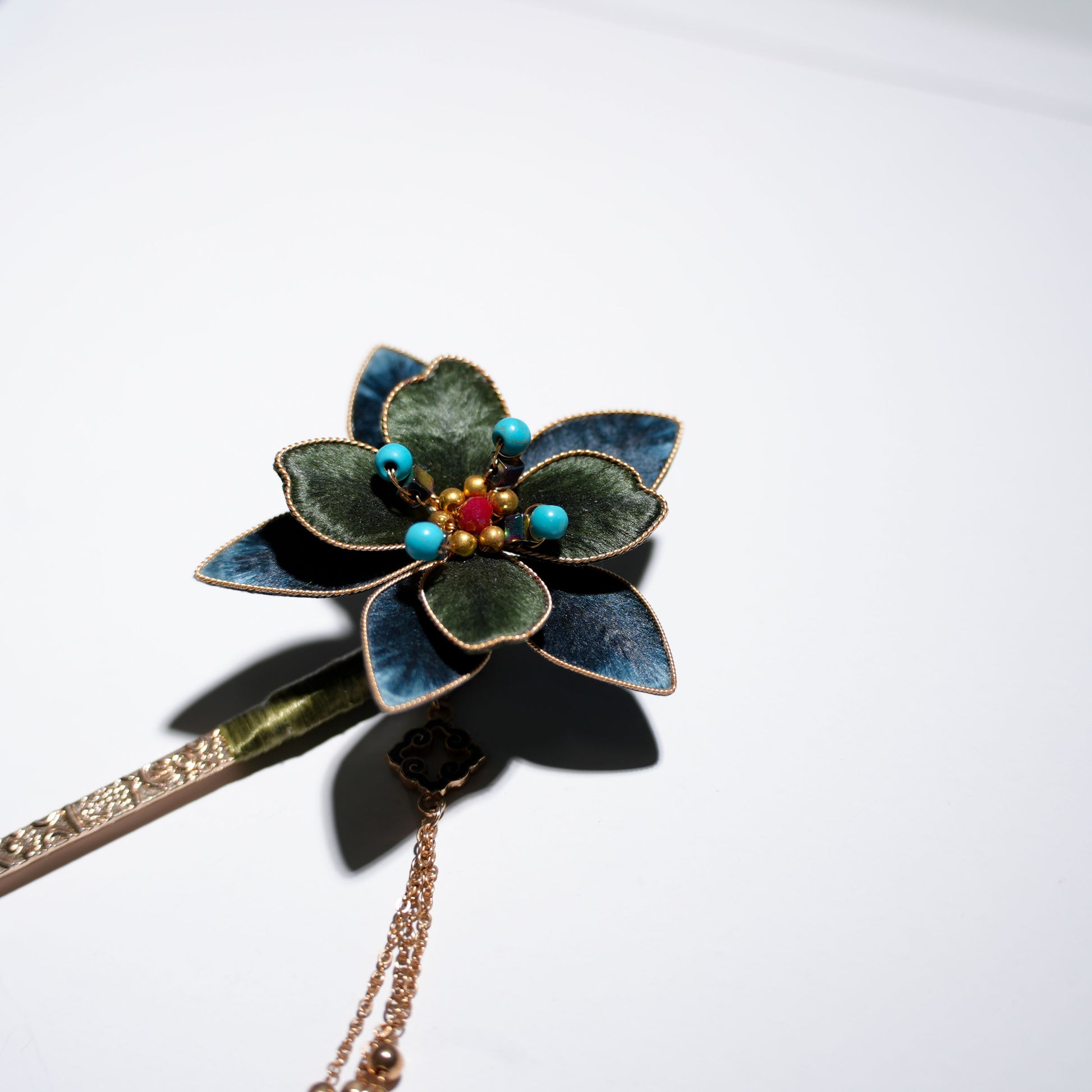 Traditional velvet flower hair stick close-up view highlighting gradient colors and pearl embellishments