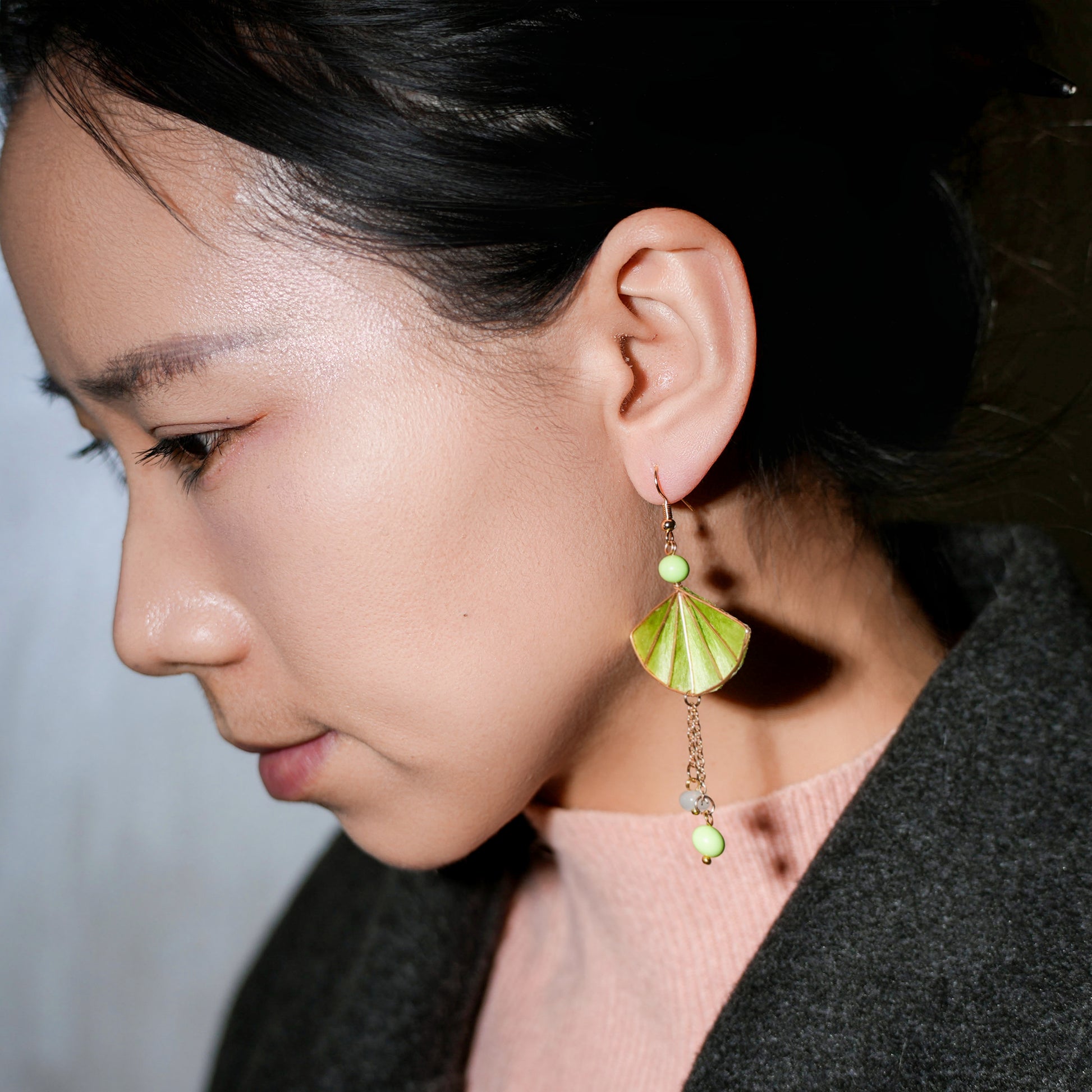 Woman wearing green velvet flower fan earrings - elegant statement jewelry styling example