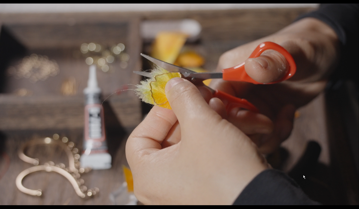 Hands crafting velvet flower ginkgo leaf ear hook showing traditional Chinese silk floss technique
