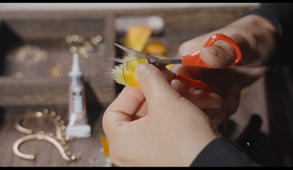 Hands crafting velvet flower ginkgo leaf ear hook showing traditional Chinese silk floss technique