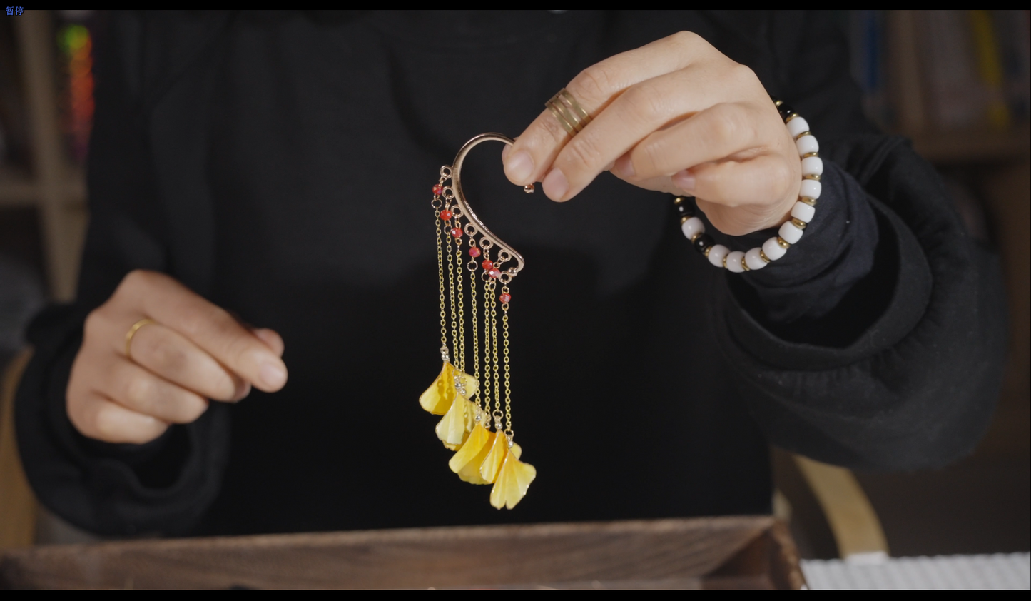 Finished Chinese velvet flower ginkgo leaf ear hooks close-up showing craftsmanship and detail