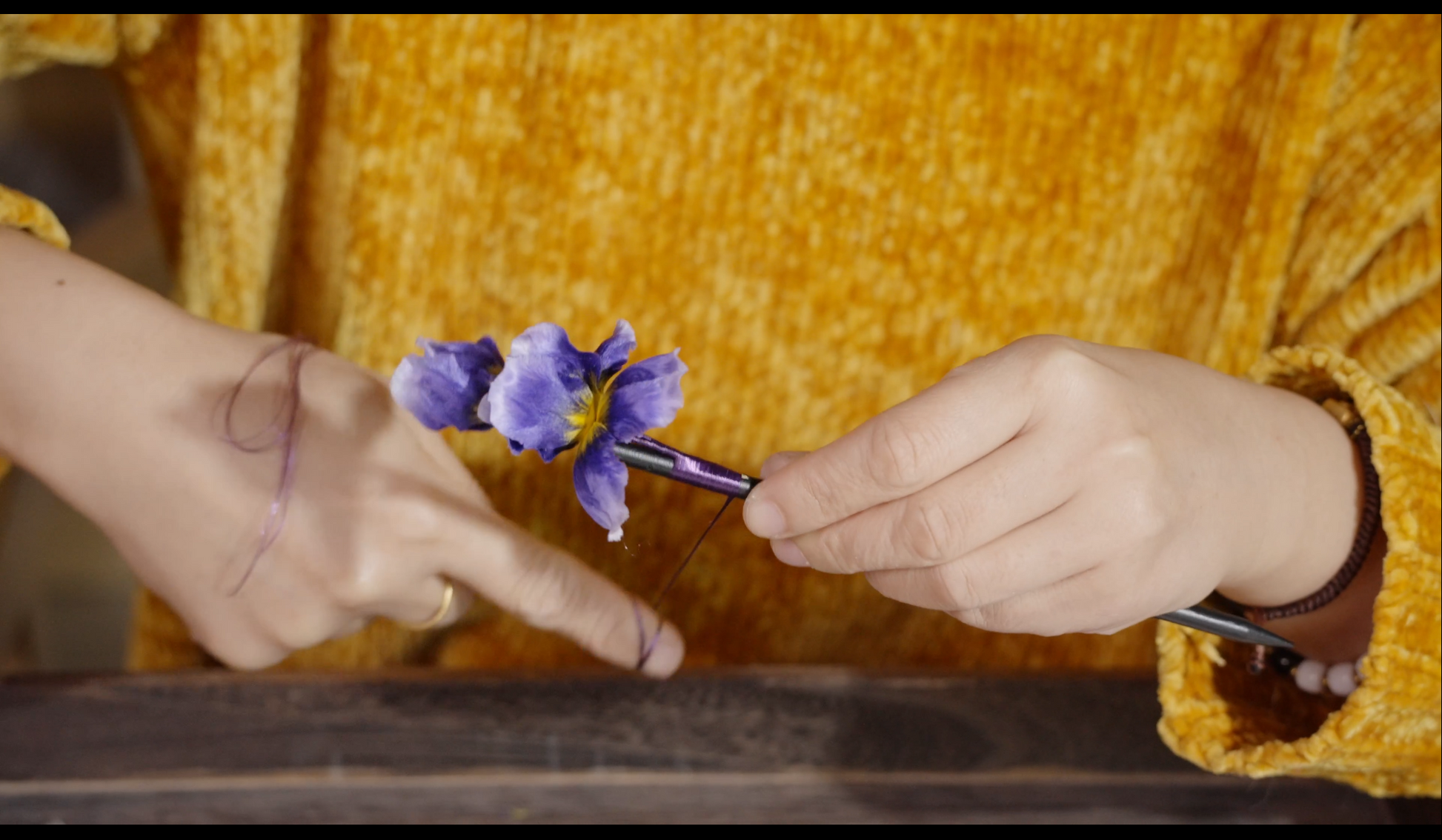 Nearly completed purple iris velvet flower hair stick showing final assembly stage